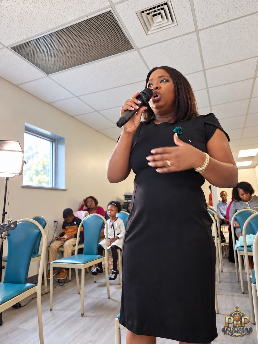 A woman worshiping with the PARACLET family