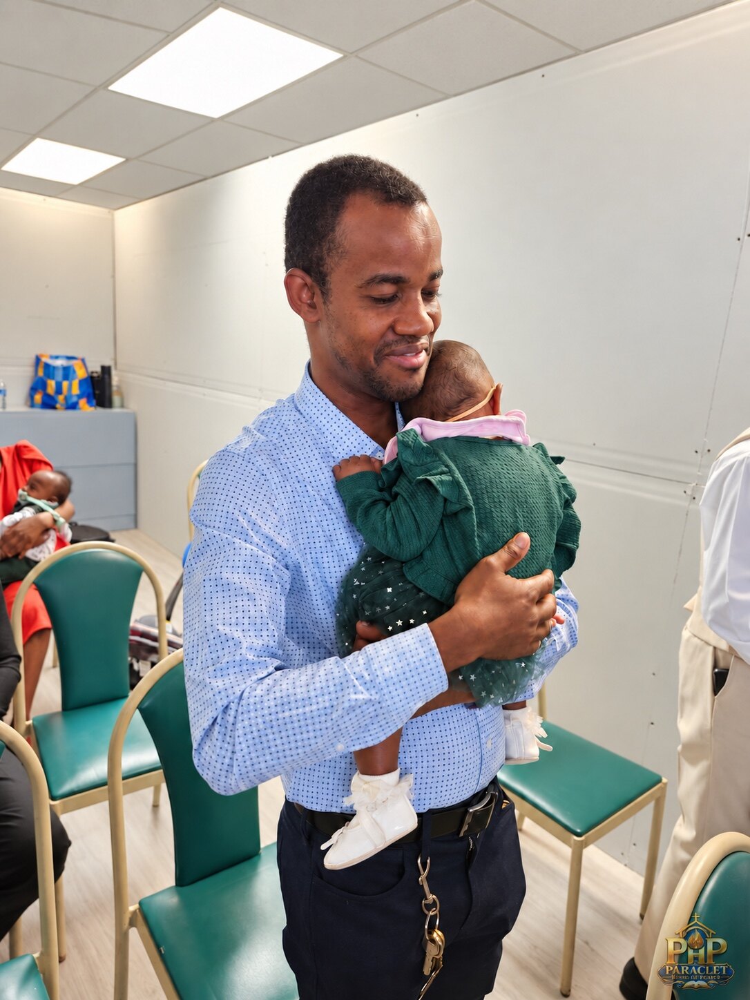 A father holding a baby during worship